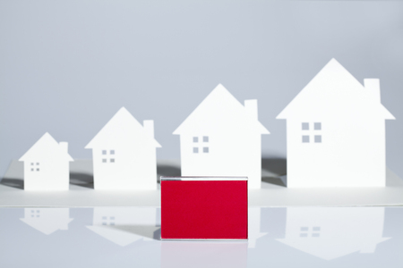 A row of simple model houses cut out of paperの写真素材