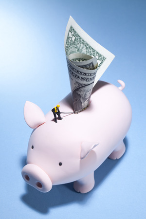 A piggy bank's journey for more moneyの写真素材