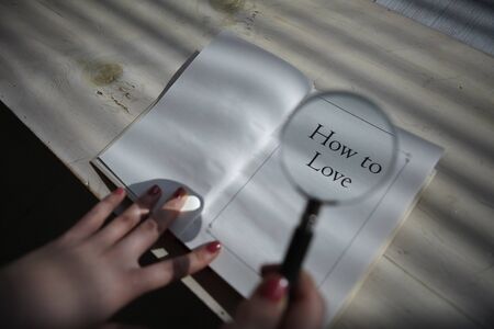 An open book with a magnifying glassの写真素材
