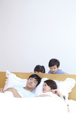 Son And Daughter Bothering Their Parentsの写真素材