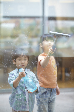 Brother And Sister Cleaning The Windowの写真素材