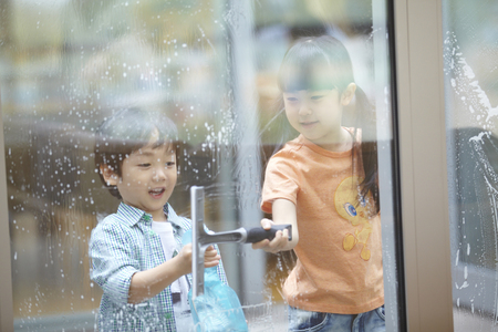 Brother And Sister Cleaning The Windowの写真素材