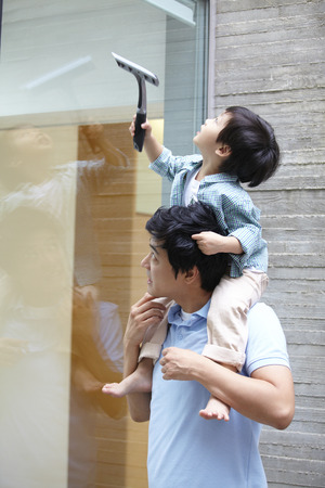 Father And Son Cleaning The Windowの写真素材
