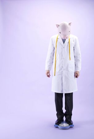 Dietitian wearing a pig maskの写真素材