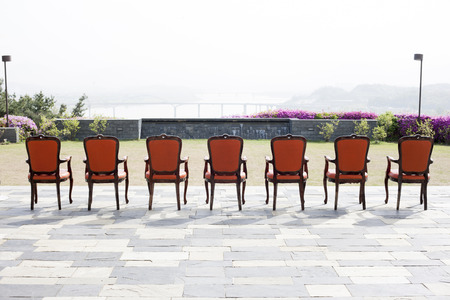 Seven chairs placed in the gardenの写真素材