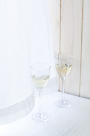 Two Filled Wine Glasses By The Windowの写真素材