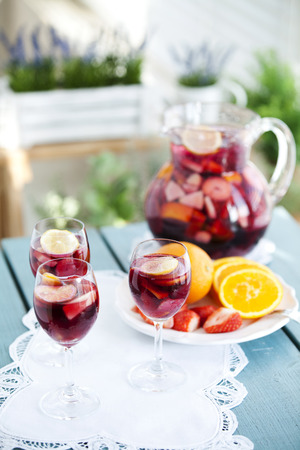 Mixed Alcoholic Drink In A Pitcher Next To Three Full Glassesの写真素材