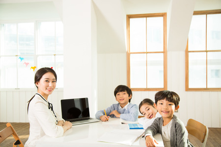 Young Students Learning With A Female Teacherの写真素材