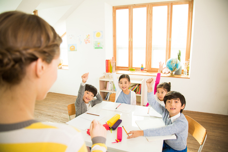 Young Students Learning With A Foreign Female Teacherの写真素材