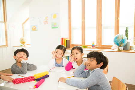 Young Students Listening To The Teacherの写真素材
