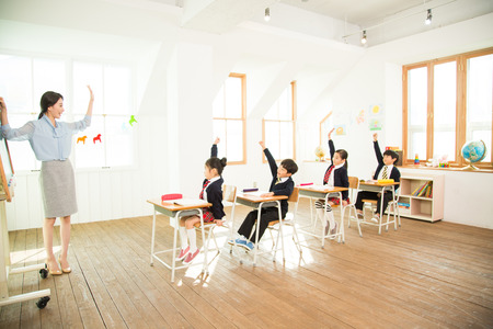 Young Students In Class With A Female Teacherの写真素材