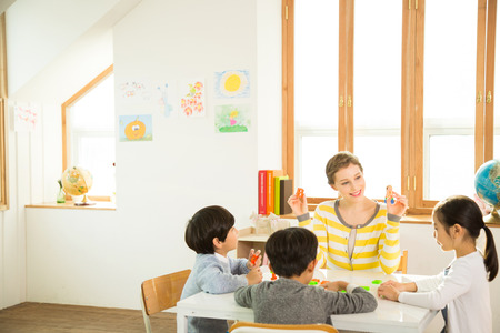 Young Students Learning English With A Foreign Female Teacher
