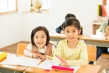 Two Young Female Students In Classの写真素材