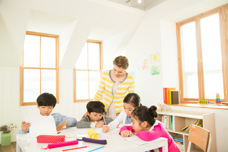 Young Students Learning With A Foreign Female Teacher