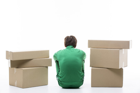 Young Unemployed Male In Green Tracksuit In Between Blank Boxesの写真素材