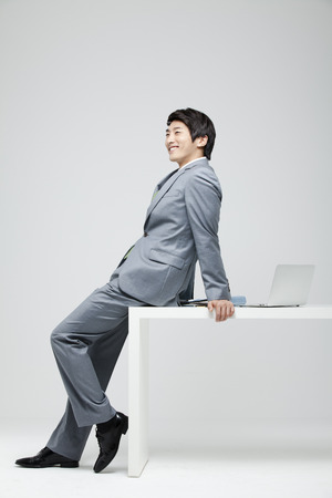 Young Businessman In Full Suit At The Deskの写真素材