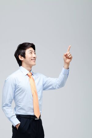 Young Businessman With Jacket Off Standingの写真素材