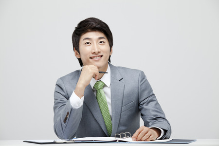 Young Businessman In Full Suit At The Deskの写真素材
