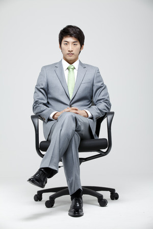 Young Businessman In Full Suit Sittingの写真素材