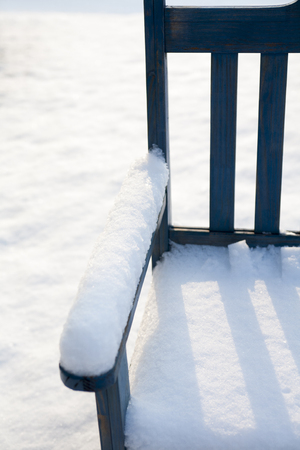 Snow-covered benchの写真素材
