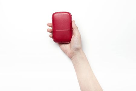 Close up shot of a red leather business card holder with hands-isolated on whiteの写真素材