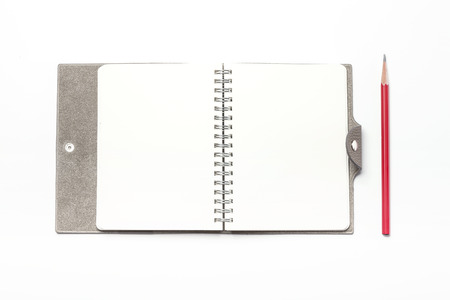 Close up shot of a grey/brown diary with hands-isolated on whiteの写真素材