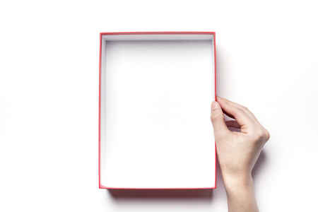 Close up shot of hands holding a red box-isolated on whiteの写真素材