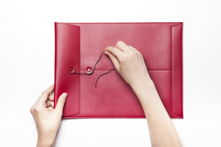 Red leather envelope-isolated on whiteの写真素材