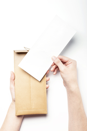 Beige leather envelope-isolated on whiteの写真素材