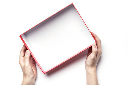 Close up shot of hands holding a red box-isolated on whiteの写真素材