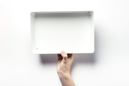 Close up shot of two hands holding and opening white plastic containers-isolated on whiteの写真素材