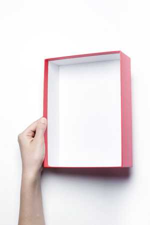 Close up shot of hands holding a red box-isolated on whiteの写真素材
