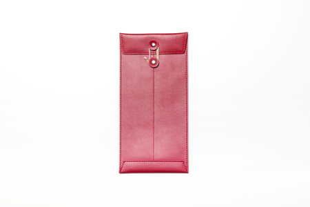 Red leather small envelope-isolated on whiteの写真素材