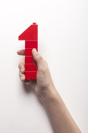 Close up shot of colorful blocks with hands-isolated on whiteの写真素材