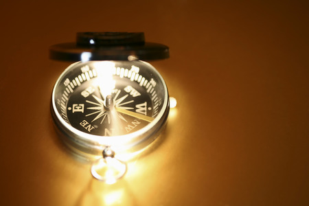 Compass - isolated on yellow backgroundの写真素材