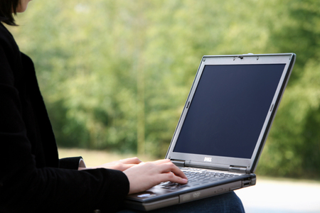 Working on a laptop, outdoorsの写真素材