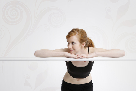 Caucasian girl smiling and leaning on the barの写真素材