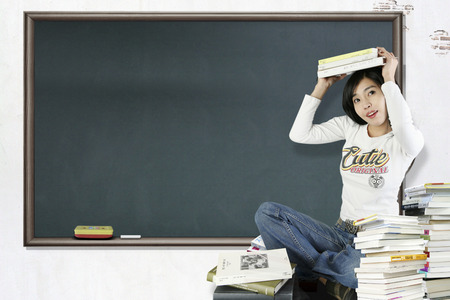 Asian female student posing with a few booksのeditorial素材