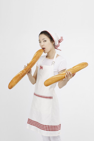 Asian students with cooking concept- Isolated on studio shotの写真素材