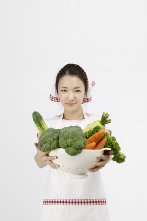 Asian students with cooking concept- Isolated on studio shotの写真素材