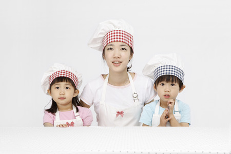 Asian students and kids with cooking concept- Isolated on studio shotの写真素材