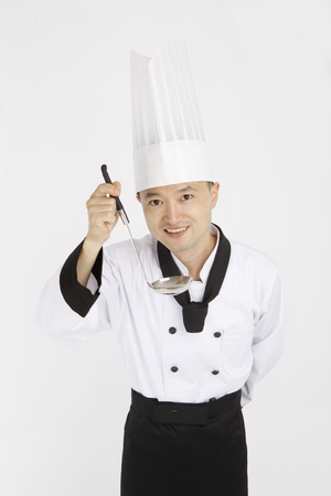 Asian students with cooking concept- Isolated on studio shotの写真素材