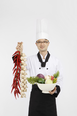 Asian students with cooking concept- Isolated on studio shotの写真素材