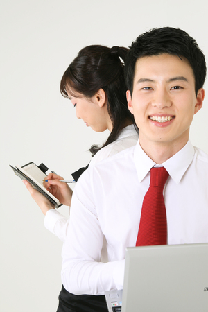 Asian business people in the studio - isolated on whiteの写真素材