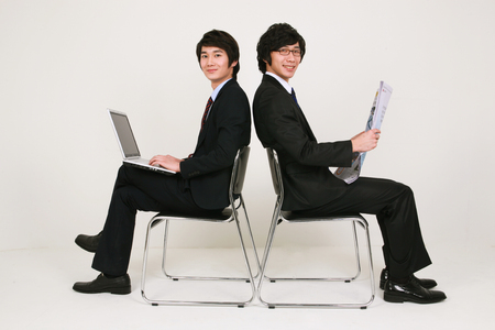 Asian business people in the studio - isolated on whiteの写真素材