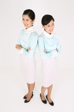 Asian flight attendants - isolated on whiteの写真素材