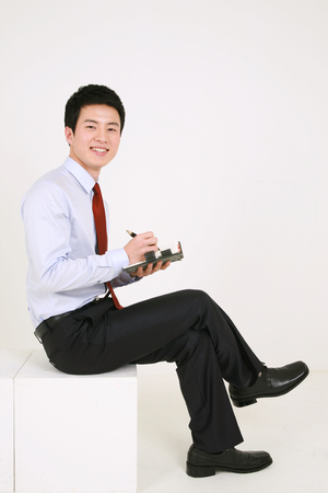 Asian business people in suit - isolated on whiteの写真素材