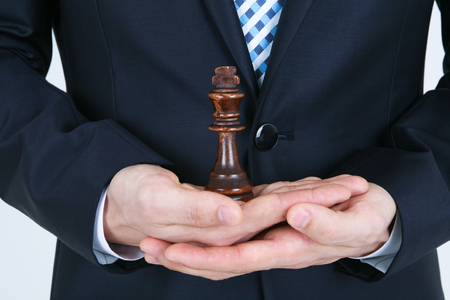 Asian business man with chess pieces - isolated on whiteの写真素材