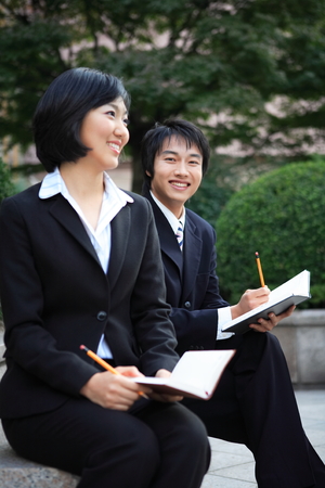 Young Asian business people outside the officeの写真素材