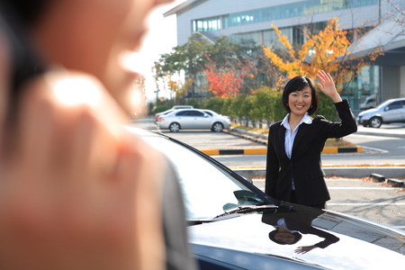 Young Asian business people outside the officeの写真素材